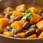 A hearty bowl of squash and kidney beans simmered together, showcasing tender chunks of squash and vibrant kidney beans in a flavorful broth.