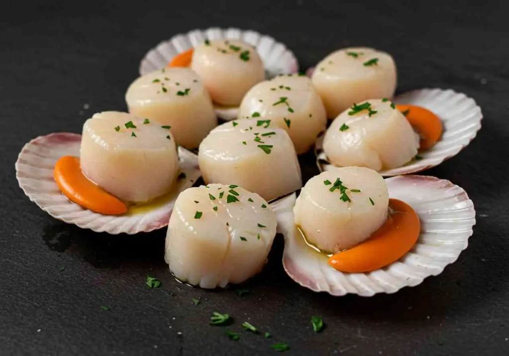 Golden-brown seared scallops sizzling in a nonstick skillet, cooked to perfection with a crispy crust.